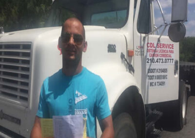 An elated graduate from Fast Track CDL Dallas TX holding up their CDL, ready to embark on a rewarding career in the trucking industry.